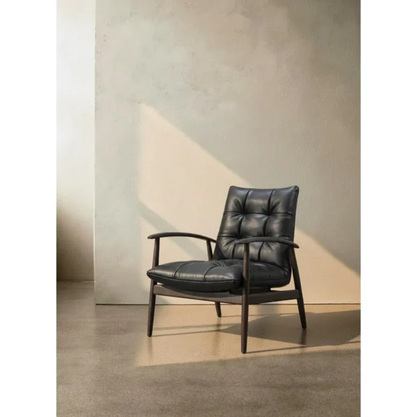 Brook Black Solid Wood Armchair with Tufted Leather Cushions in black — in a room setting