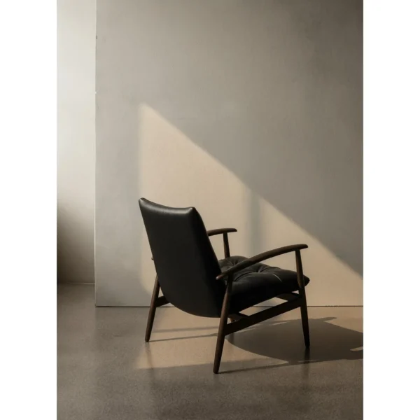 Brook Black Solid Wood Armchair with Tufted Leather Cushions in black — in a room setting