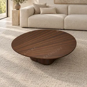 Fia Round Walnut Coffee Table on Sculpted Organic Base in walnut — in a room setting