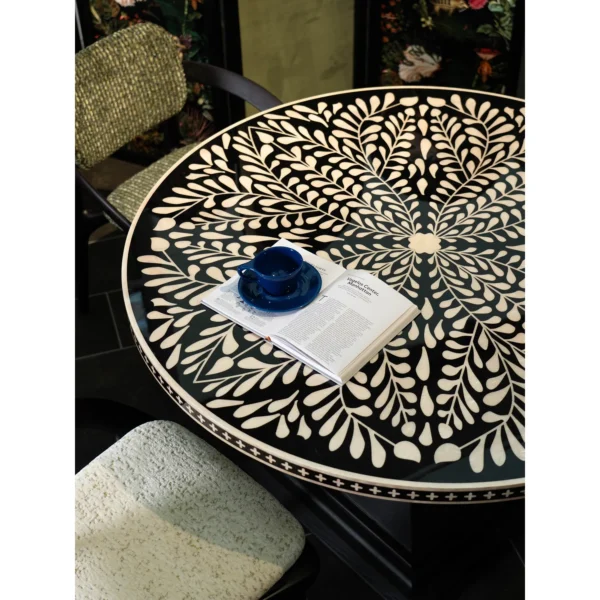 Mother-of-Pearl Inlaid Round Dining Table in black — in a room setting