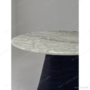 Movement Round Marble Table on Wave-Layered Black Base in ivory — in a room setting