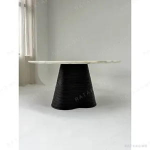 Movement Round Marble Table on Wave-Layered Black Base in ivory — in a room setting