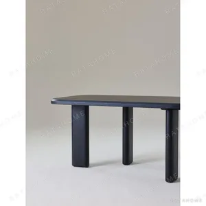 Moyu Black Dining Table with Cane Armchairs in black — in a room setting