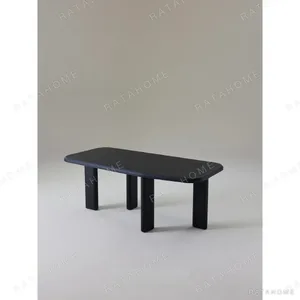 Moyu Black Dining Table with Cane Armchairs in black — in a room setting
