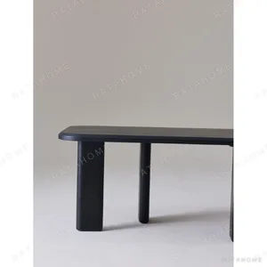 Moyu Black Dining Table with Cane Armchairs in black — in a room setting