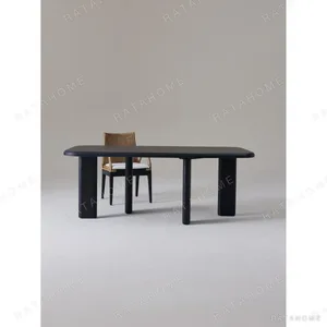 Moyu Black Dining Table with Cane Armchairs in black — in a room setting