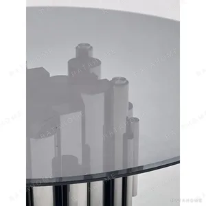 Grey Glass Round Table on Mirror-Steel Column Cluster in slate — in a room setting