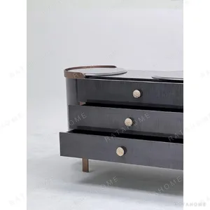 Curved Black Art-Texture Cabinet with Metal Trim and Drawers in black — in a room setting