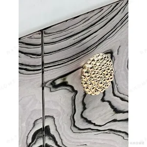 Curved Black Art-Texture Cabinet with Metal Trim and Drawers in black — in a room setting