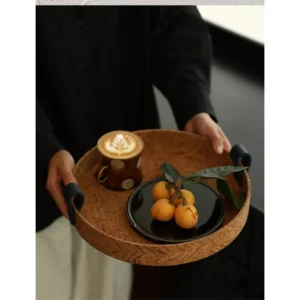 Natural Cork Round Tray with Leather Strap Handles in clay — in a room setting