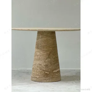 Cream Travertine Round Dining Table on Cone Base in oatmeal — in a room setting