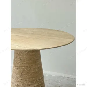 Cream Travertine Round Dining Table on Cone Base in oatmeal — in a room setting