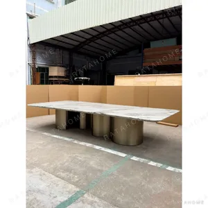 Long Grey-Veined Marble Dining Table on Champagne Columns in ivory — in a room setting
