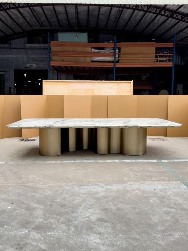 Long Grey-Veined Marble Dining Table on Champagne Columns in ivory — in a room setting