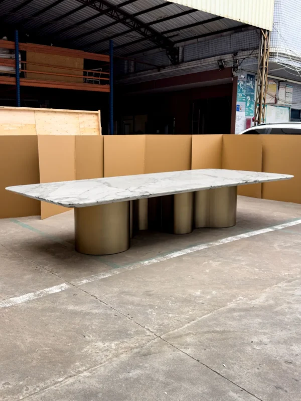 Long Grey-Veined Marble Dining Table on Champagne Columns in ivory — in a room setting