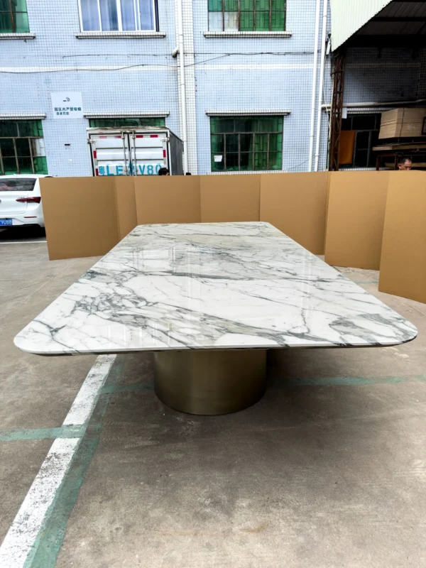 Long Grey-Veined Marble Dining Table on Champagne Columns in ivory — in a room setting