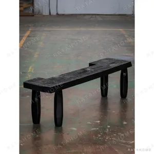 Charred Black Solid Wood Bench with Sculpted Legs in black — in a room setting