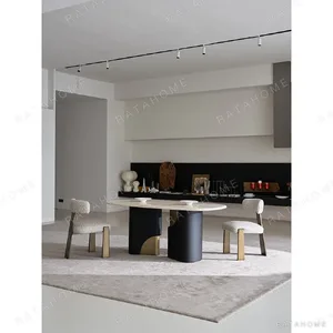 Travertine Oval Dining Table on Black Oak Columns with Brass in oatmeal — in a room setting