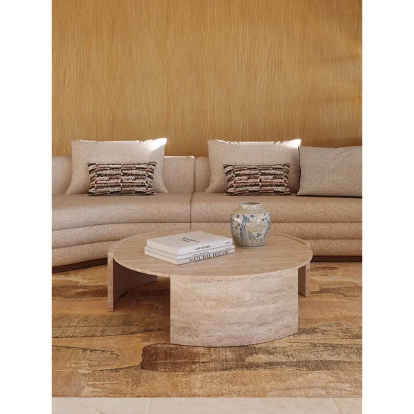Round Natural Travertine Coffee Table on Three-Arc Ring Base in sand — in a room setting