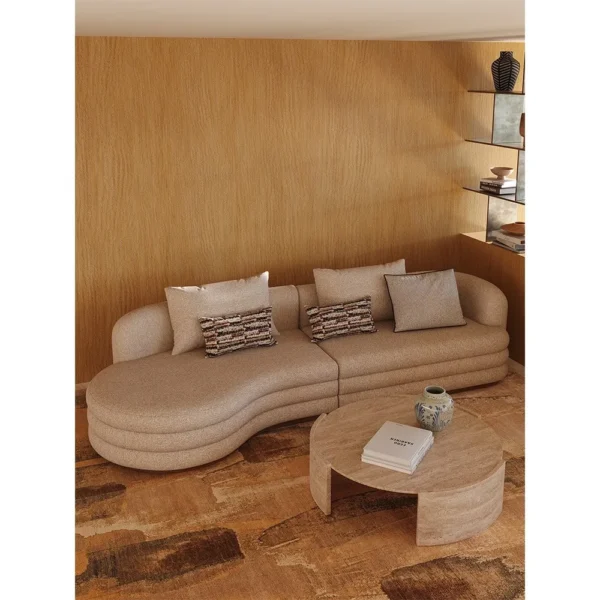 Round Natural Travertine Coffee Table on Three-Arc Ring Base in sand — in a room setting