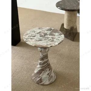 Natural Veined Marble Round Side Table on Sculpted Base in olive — in a room setting
