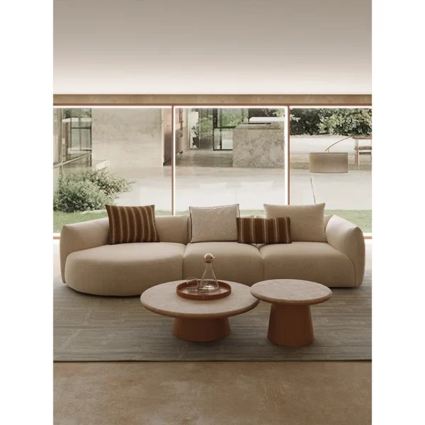 Naturalist Curved Modular Sofa in sand — in a room setting