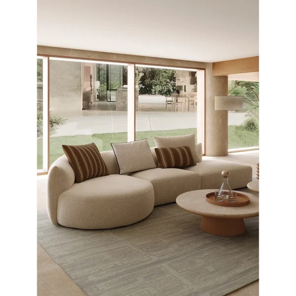 Naturalist Curved Modular Sofa in sand — in a room setting