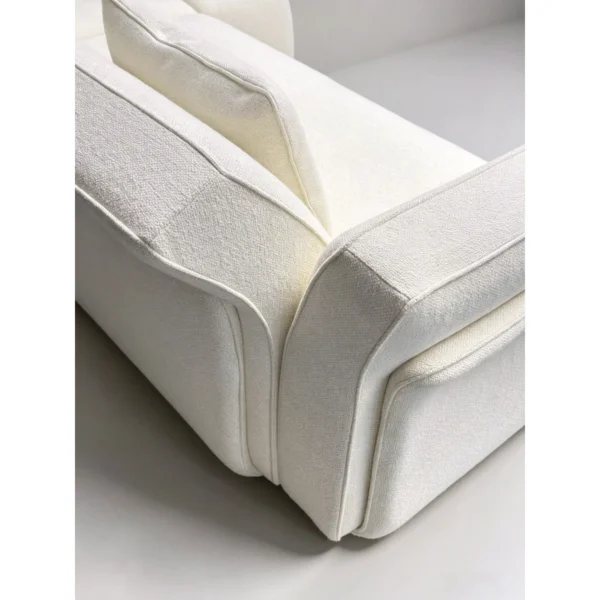 Negative Space Corner Sofa in Cream Fabric on Walnut Plinth — in a room setting