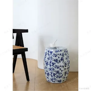 Blue and White Bird and Blossom Ceramic Drum Stool in blue — in a room setting