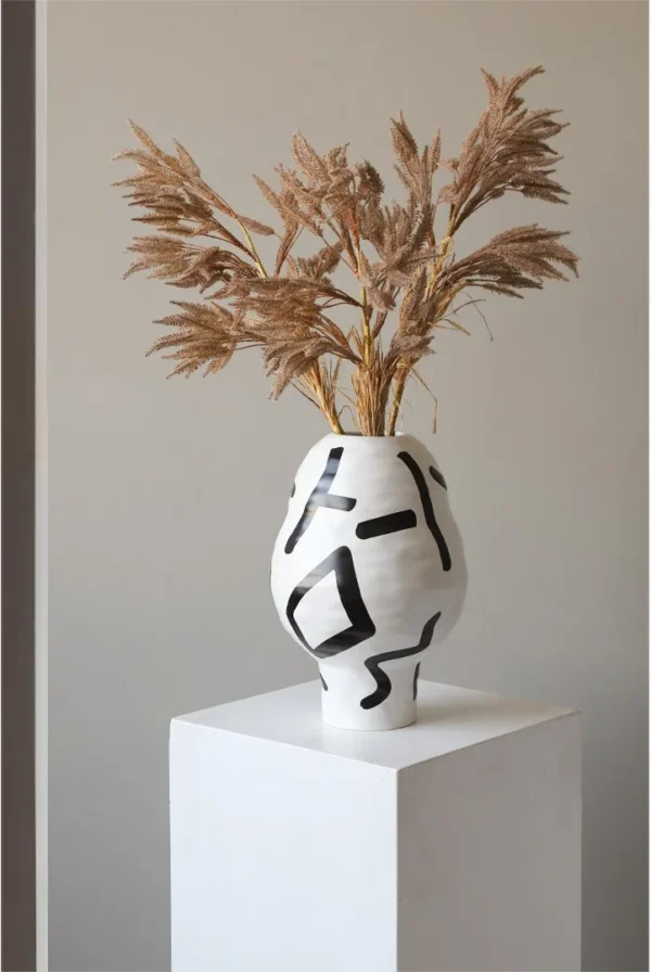 White Ceramic Lantern Vase with Black Lines, Medium in ivory — in a room setting