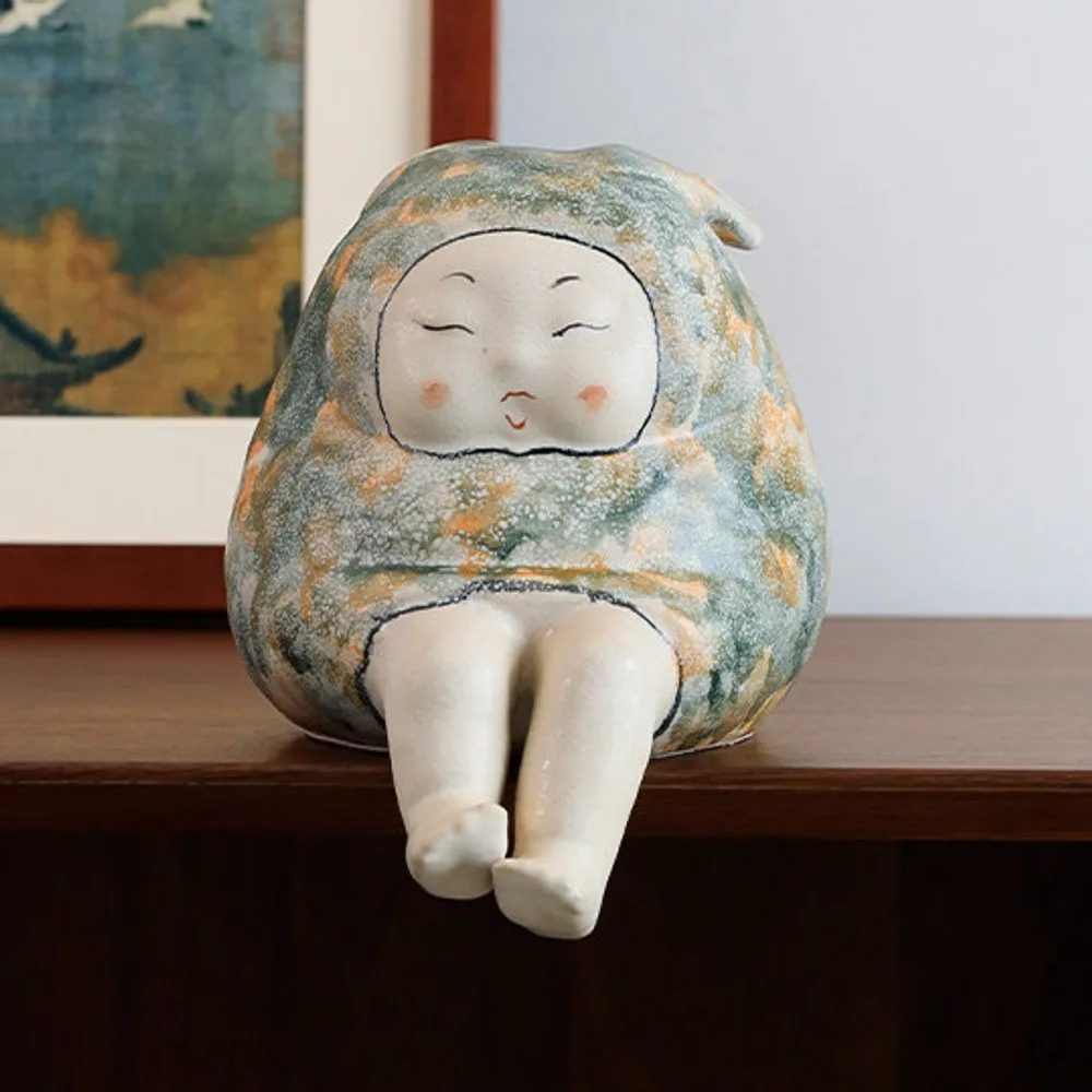 Smiling Face Seated Figure Ceramic Sculpture in olive — front view