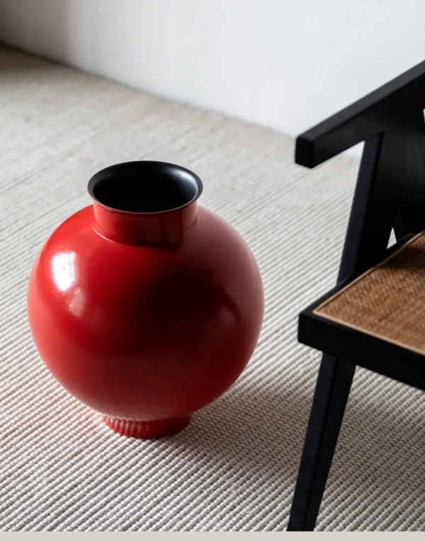 Cinnabar Red Glossy Round-Belly Ceramic Vase with Flared Lip in red — in a room setting