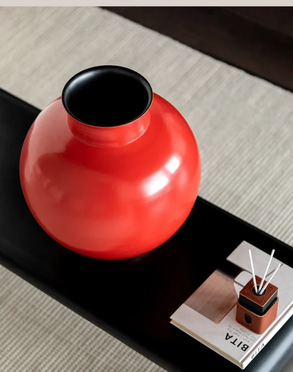 Cinnabar Red Glossy Round-Belly Ceramic Vase with Flared Lip in red — in a room setting