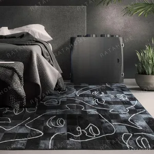 Line Drawn Faces Art Rug in Black and White — in a room setting