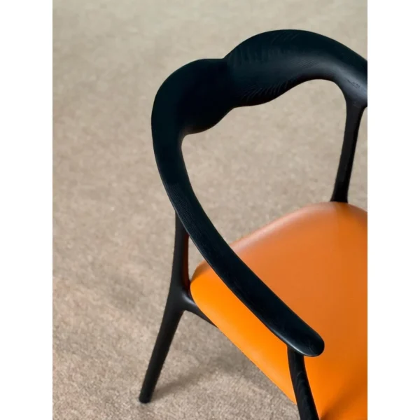 Black Bentwood Sculptural Dining Chair with Tan Leather Seat in black — in a room setting