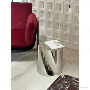 Twisted Cylinder Mirror Steel Side Table in silver — in a room setting