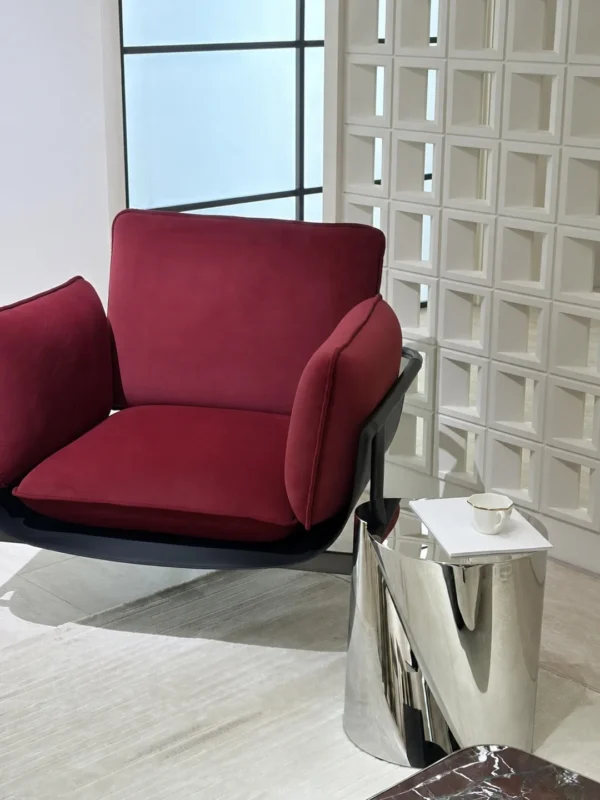 Twisted Cylinder Mirror Steel Side Table in silver — in a room setting