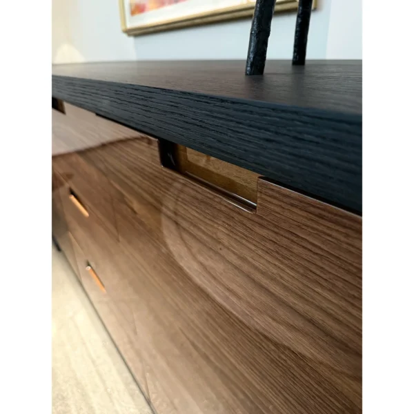 Noye Smoked Oak and Gloss Walnut Sideboard in black — in a room setting