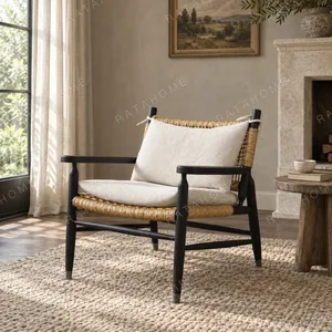 Black Oak Lounge Chair with Rattan Seat and Down Cushion in black — in a room setting
