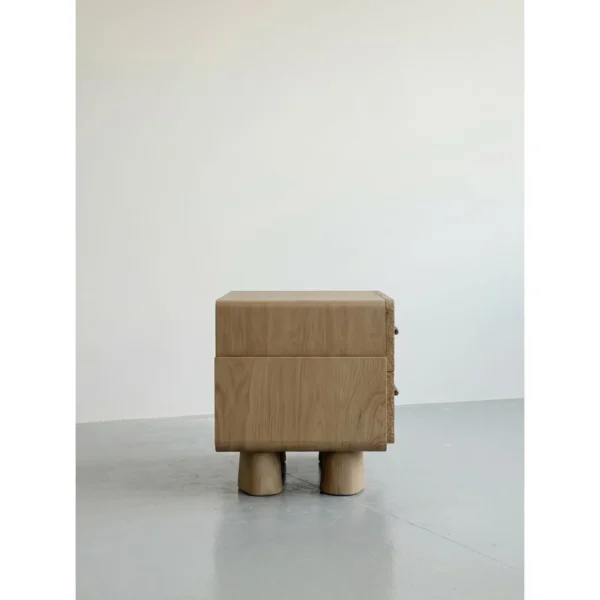 Hand-Chiselled White Oak Nightstand on Sculpted Legs in natural oak — in a room setting