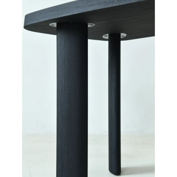 Matte Black Oak Desk with Curved End and Leather Inset in black — in a room setting
