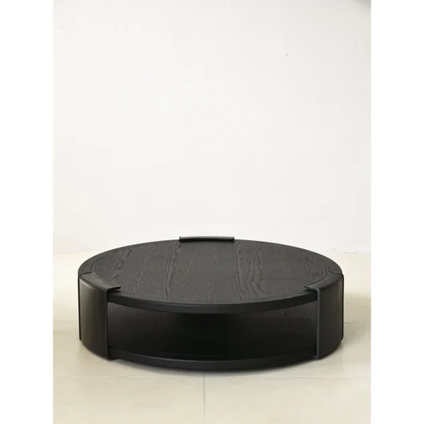 Round Black Oak Coffee Table with Brass Detail, 130 cm in black — in a room setting