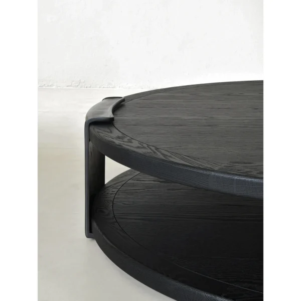 Round Black Oak Coffee Table with Brass Detail, 130 cm in black — in a room setting