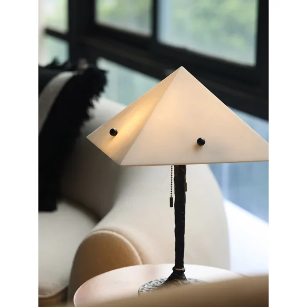 Faux Alabaster Pyramid Table Lamp with Antique Brass Base in ivory — in a room setting