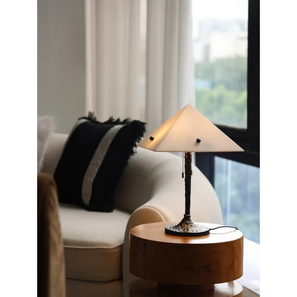 Faux Alabaster Pyramid Table Lamp with Antique Brass Base in ivory — in a room setting