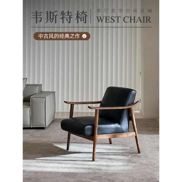 West Mid-Century Ash Armchair in Black Faux Leather — in a room setting