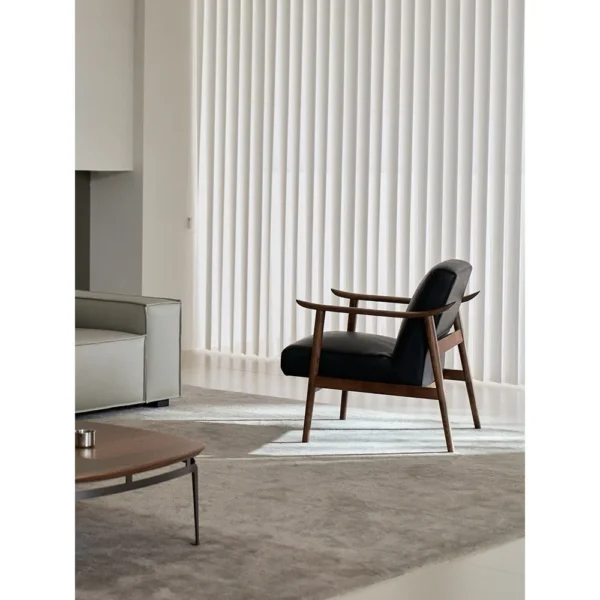 West Mid-Century Ash Armchair in Black Faux Leather — in a room setting