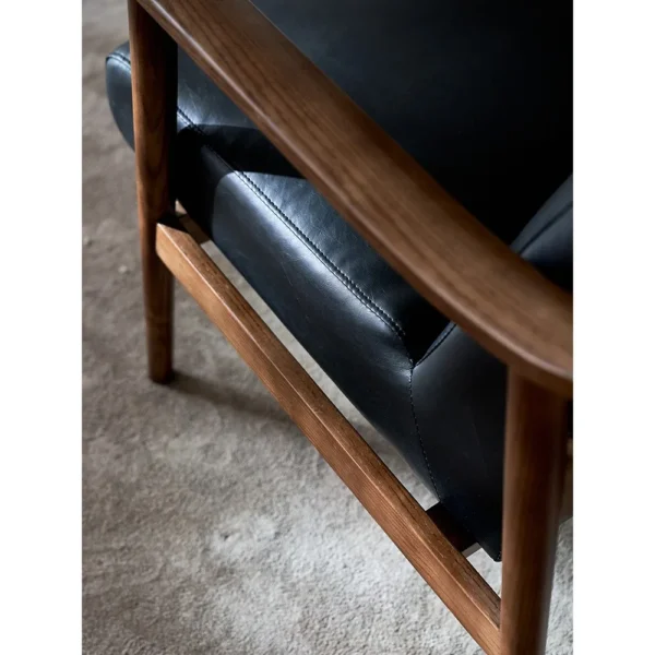West Mid-Century Ash Armchair in Black Faux Leather — in a room setting