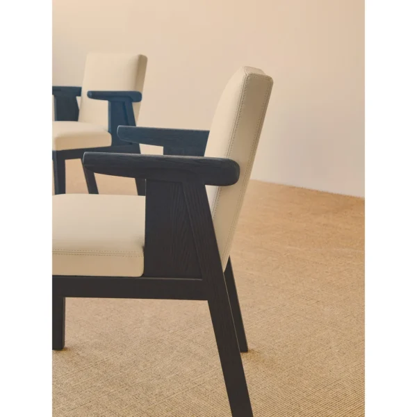 Black Oak Dining Chair with Cream Leather and Wrapped Arms in oatmeal — in a room setting