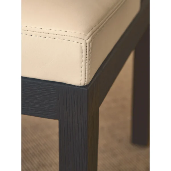 Black Oak Dining Chair with Cream Leather and Wrapped Arms in oatmeal — in a room setting